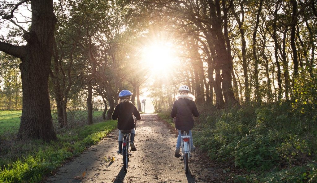 Girls riding bikes into the sunset