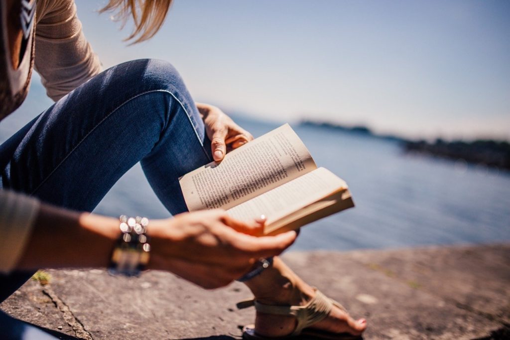 woman reading on the beach